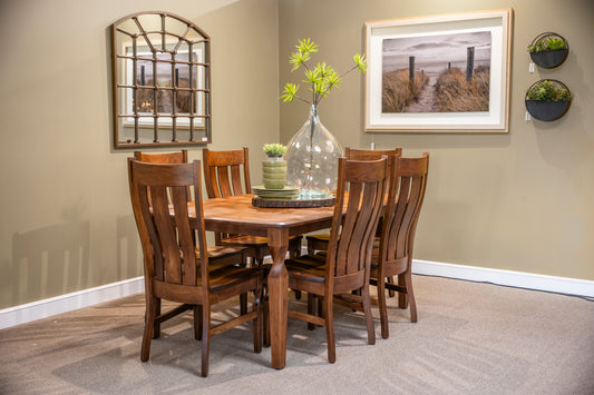 A 6-piece wooden dining room set consisting of a rectangular table and six matching slatted chairs, styled in a dining room corner with a large glass vase, small potted plants, and framed wall art.