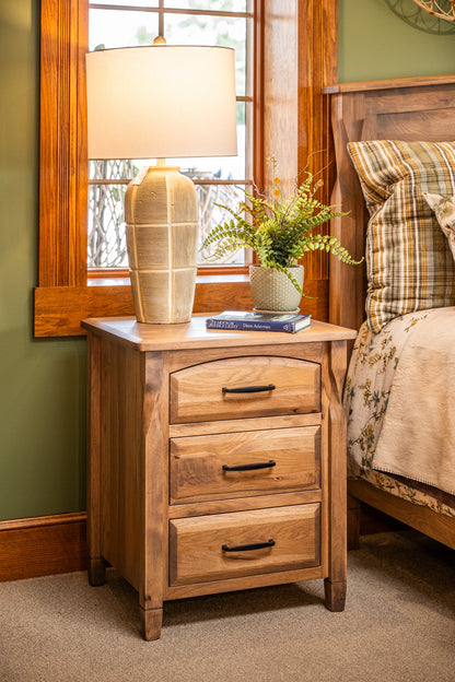 Brantley 3 Drawer Nightstand displayed beside the bed